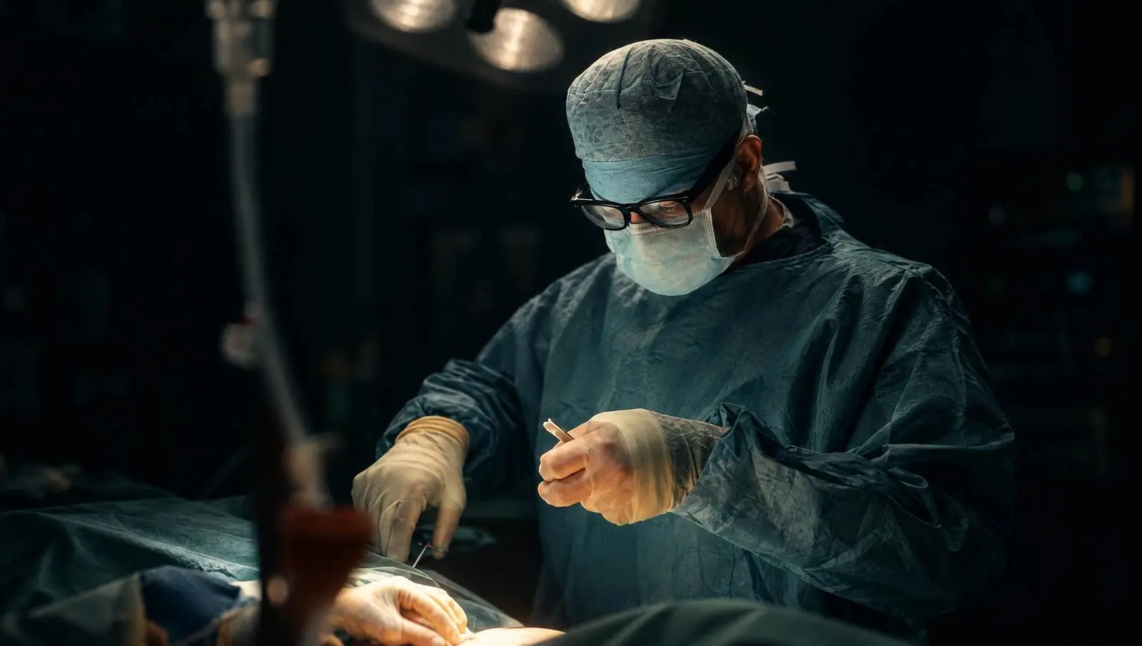 Mr Reza Nassab, Consultant Plastic Surgeon, in theatre